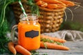Fresh Carrot and carrot juice on Wooden Table in Garden. Vegetables Vitamins Keratin. Natural Organic Carrot lies on Royalty Free Stock Photo