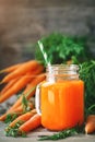 Fresh Carrot and carrot juice on Wooden Table in Garden. Vegetables Vitamins Keratin. Natural Organic Carrot lies on Royalty Free Stock Photo