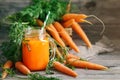 Fresh Carrot and carrot juice on Wooden Table in Garden. Vegetables Vitamins Keratin. Natural Organic Carrot lies on Royalty Free Stock Photo