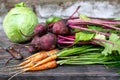 Fresh carrots, beets and cabbage on wooden background, selective focus