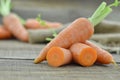 Fresh carrots and cut carrots on wooden table, rustic Royalty Free Stock Photo