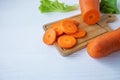 Fresh carrots cut on a wooden chopping board. Royalty Free Stock Photo