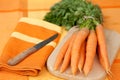 Fresh carrots on a cutting board with knife