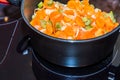 Fresh carrots and onions frying in pan casserole Royalty Free Stock Photo