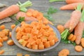 Fresh carrots and raw plate with diced and sliced on wooden table Royalty Free Stock Photo