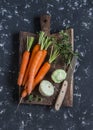Fresh carrots, squash, oregano, thyme on a wooden cutting board Royalty Free Stock Photo