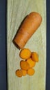 fresh carrots on a wooden mat with a black background