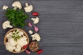 Fresh cauliflower with garlic and chili peppers on black wooden background with copy space for your text. Top view Royalty Free Stock Photo