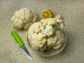 Fresh cauliflower, half a lemon, a wooden cutting board and a knife on the kitchen table. Flat layout. Place for text Royalty Free Stock Photo