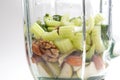 Fresh Celery, avocado, almonds, pears in a glass blender for cooking a green smoothie. Healthy eating.