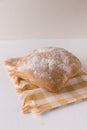 Fresh chabata bread on a yellow towel on a white background Royalty Free Stock Photo