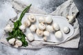 Fresh champignon mushrooms on a white chopping Board. Gray background. Top view Royalty Free Stock Photo