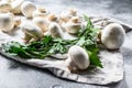 Fresh champignon mushrooms on a white chopping Board. Gray background. Top view Royalty Free Stock Photo