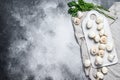 Fresh champignon mushrooms on a white chopping Board. Gray background. Top view. Space for text Royalty Free Stock Photo