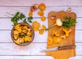 fresh chanterelle mushrooms with fresh vegetables, onions, garlic, parsley, on a board with a cooking knife, top view. Royalty Free Stock Photo