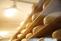 Fresh cheese heads on rack