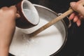 Fresh cheese making step by step, hot milk into a pot, vinegar or lemon juice for clotting Royalty Free Stock Photo