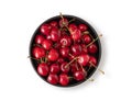 Fresh cherries in a black bowl on a white isolated  background. Top view and copy space Royalty Free Stock Photo