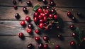 Fresh cherries in a bowl on the dark wood table. Royalty Free Stock Photo