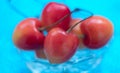 Fresh cherries close up macro on blurred blue background. Selective focus. Natural, organic, vitamin food. Healthy eating concept Royalty Free Stock Photo