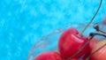 Fresh cherries close up macro on blurred blue background. Selective focus. Natural, organic, vitamin food. Healthy eating concept Royalty Free Stock Photo