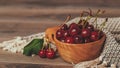 Fresh cherries with green leaves in wooden bowl, close up Royalty Free Stock Photo