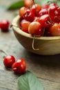 Fresh cherries with leaves in a wooden bowl Royalty Free Stock Photo