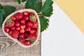 Fresh cherries and red ripe strawberries on a white plate Royalty Free Stock Photo