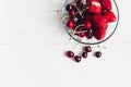 Fresh cherries and strawberries in stylish glass bowl on white r Royalty Free Stock Photo