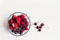 Fresh cherries and strawberries in stylish glass bowl on white r Royalty Free Stock Photo