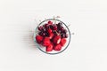 Fresh cherries and strawberries in stylish glass bowl on white r Royalty Free Stock Photo