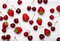 Fresh cherries and strawberries on the white wooden table Royalty Free Stock Photo