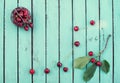 Fresh cherries in tiny metal vintage basket on rustic wooden background top view with copy space