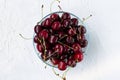 Red cherries in a bowl isolated on a white background top view Royalty Free Stock Photo