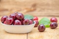 Fresh cherries in the white bowl on wood table