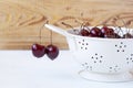 Fresh cherries in a white enamel strainer Royalty Free Stock Photo