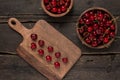 Fresh cherries on a wooden board with wooden board background on a wooden table Royalty Free Stock Photo