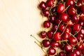 Cherry berries on a wooden background top view.Background with a cherry on a sprig.Flat lay. Royalty Free Stock Photo