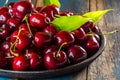 Fresh cherry on black plate, wooden background Royalty Free Stock Photo