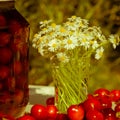 Fresh Cherry, bottled cherry and daisy flowers on table in spring