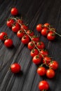 Fresh cherry tomato branch on wooden background Royalty Free Stock Photo