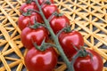 Fresh cherry tomatoes on a background of a straw mat. Royalty Free Stock Photo
