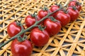 Fresh cherry tomatoes on a background of a straw mat. Royalty Free Stock Photo