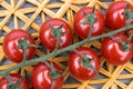 Fresh cherry tomatoes on a background of a straw mat. Royalty Free Stock Photo