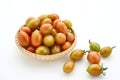 Fresh cherry tomatoes in the bamboo basket isolated on white background. Royalty Free Stock Photo