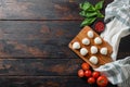 Fresh cherry tomatoes, basil leaf, mozzarella cheese on old wood background table selective focus space for text