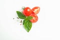 Fresh cherry tomatoes with basil and spices on white background, space for text and top view Royalty Free Stock Photo