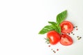 Fresh cherry tomatoes with basil and spices on white background, space for text and top view Royalty Free Stock Photo