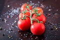 Fresh cherry tomatoes on a black background with spices. Top vie Royalty Free Stock Photo