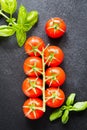 Fresh cherry tomatoes on a black background with spices. Top vie Royalty Free Stock Photo